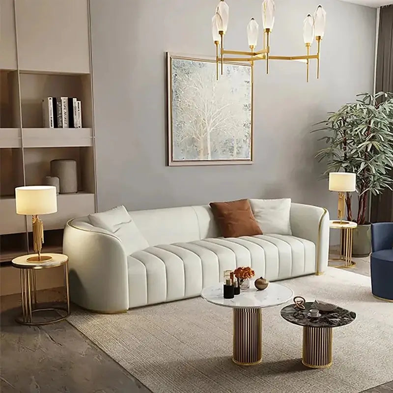 Curved luxury sofa set with ivory upholstery, gold piping, wraparound arms, and premium living room style