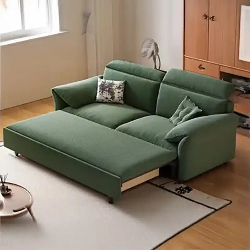  green pull-out sofa bed for compact rooms with wide padded arms, chaise-style sleeping surface, and modern sofa bed comfort