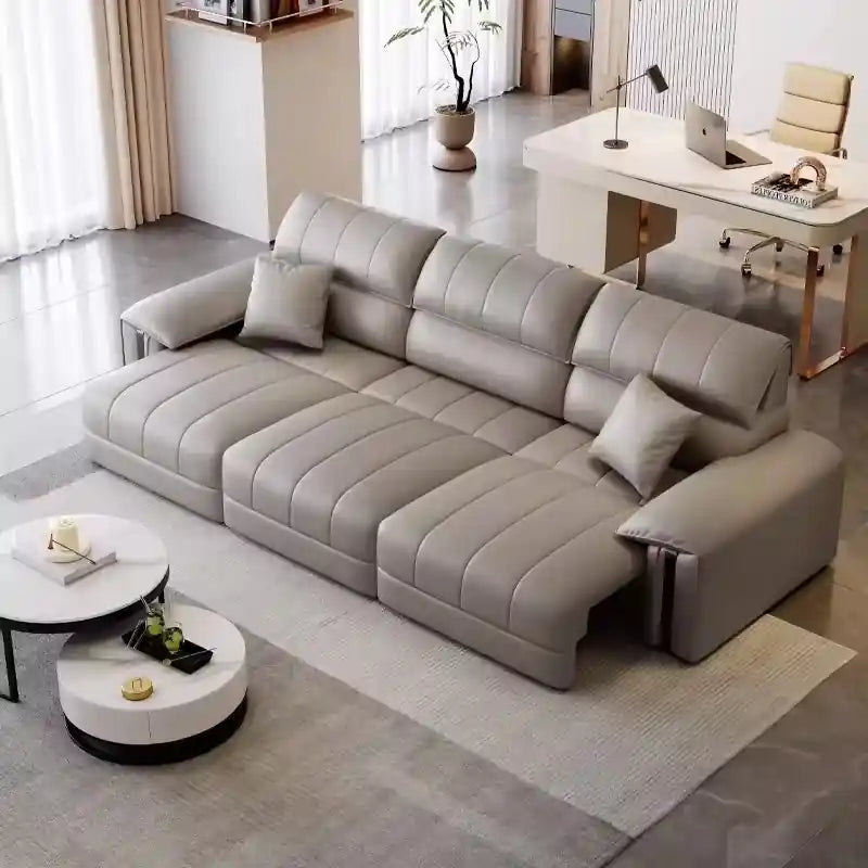 Light grey 3 seater pull-out sofa bed with leatherette finish, vertical channel stitching, pillow-top arms, and modern sofa cumm bed design