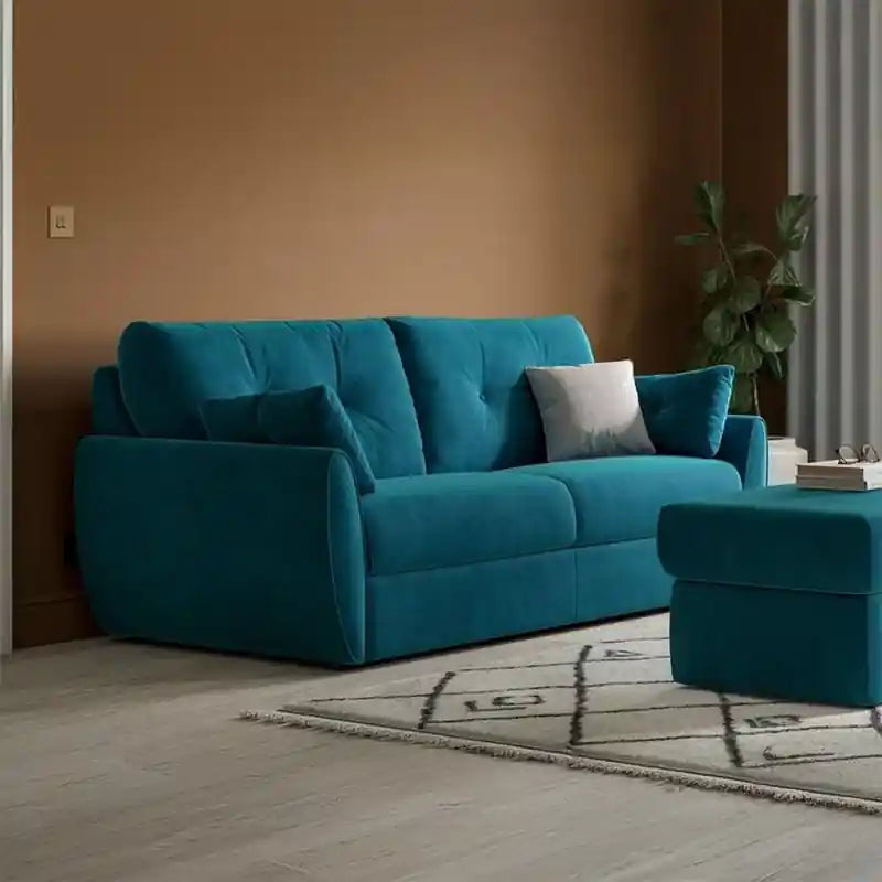  teal blue pull-out sofa bed with tufted backrest, rounded armrests, matching ottoman, and compact couch bed design