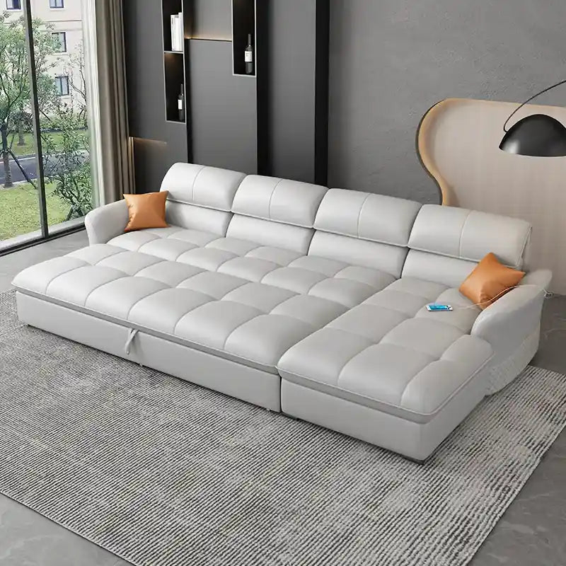  light grey sofa bed with deep tufted cushions, quilted arms, and chaise layout