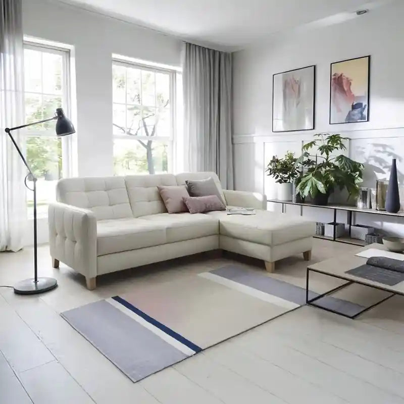  cream L shape sofa bed shown in living room view with sofa cumm bed sleeper function, chaise lounge, and compact sofa bed design