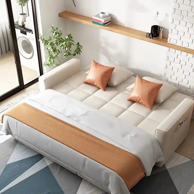 Pull-out sofa bed with square-tufted cushions, broad track arms, loose back pillows, and modern sofa cum bed design