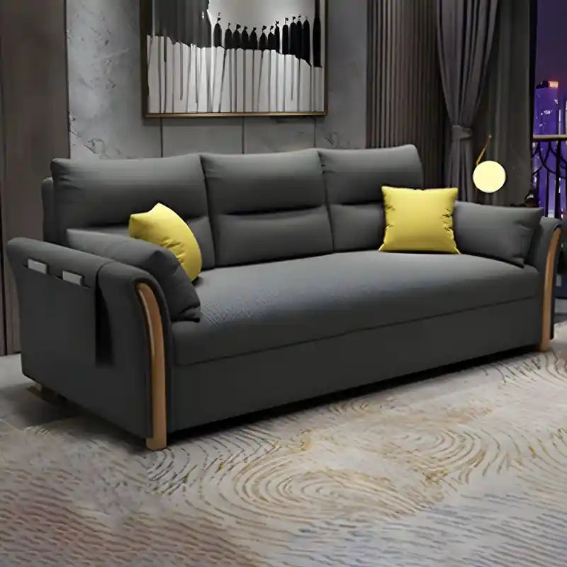dark grey sofa cam bed shown in living room view with wooden arms, side storage pocket, and compact couch bed comfort