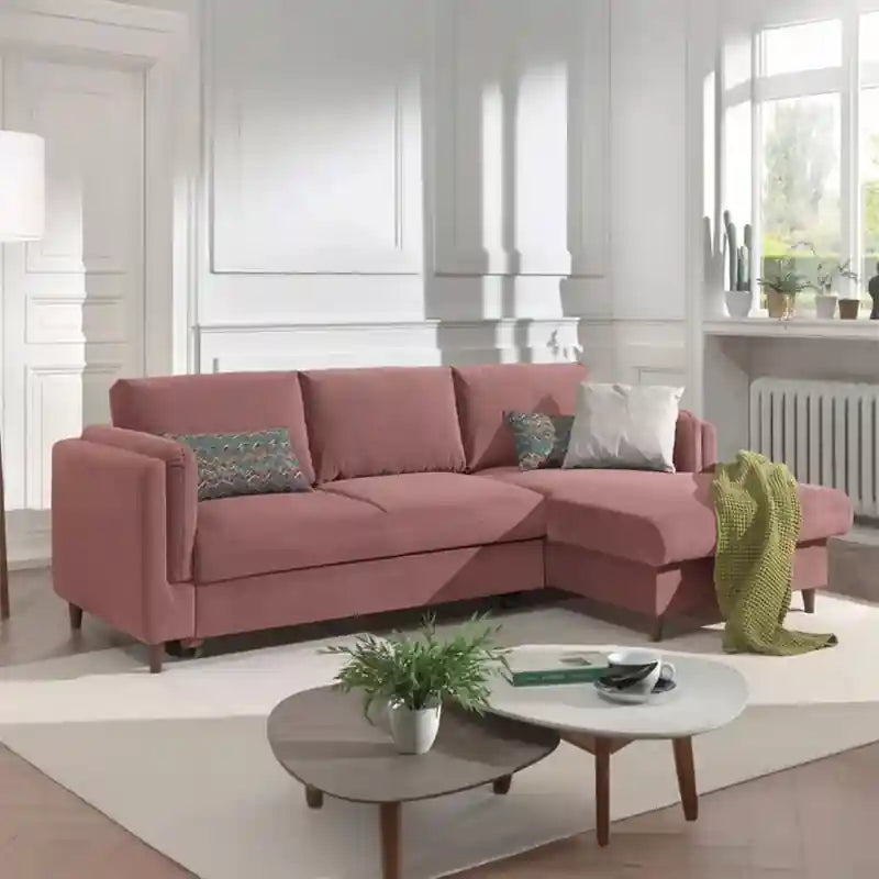 pink L shape sofa bed front view with raised wooden legs and clean modern styling