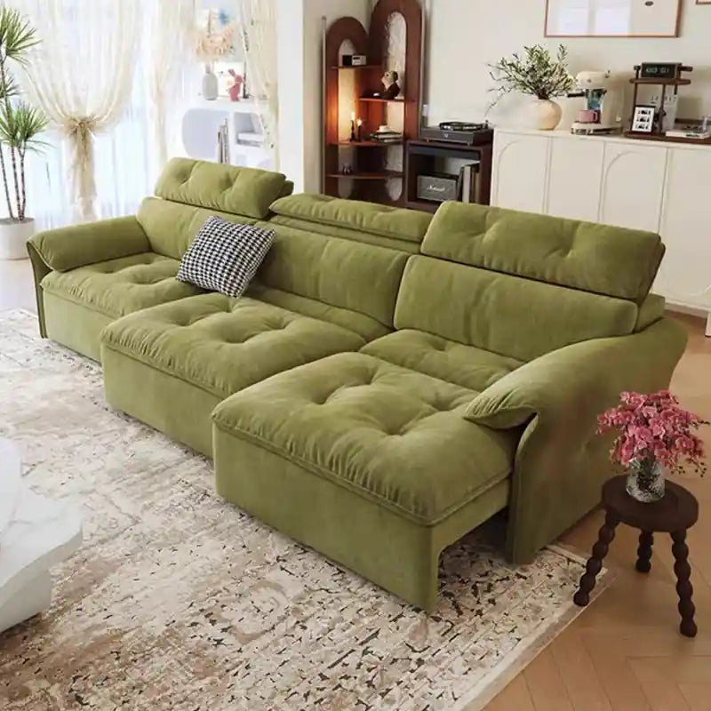 green couch bed with low-profile lounge design and soft cushions