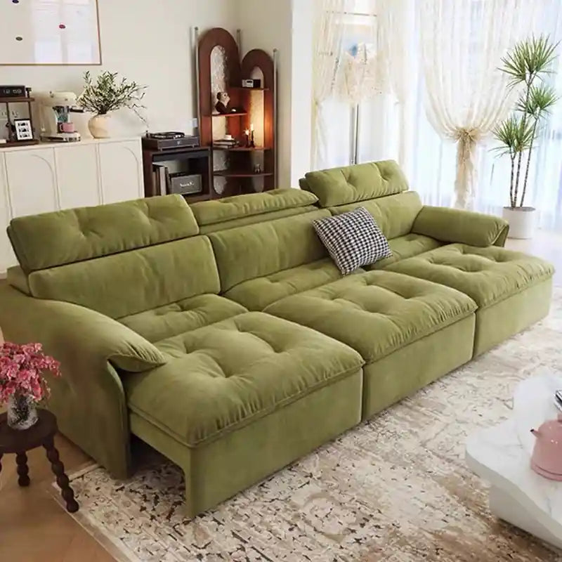 green sofa cumm bed with plush tufted cushions and padded arms