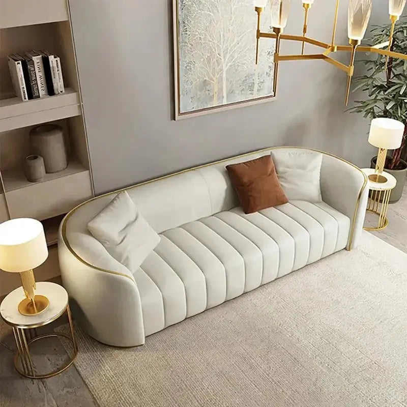 3 seater sofa with curved profile, ivory fabric upholstery, vertical tufted detailing, and modern sofa design