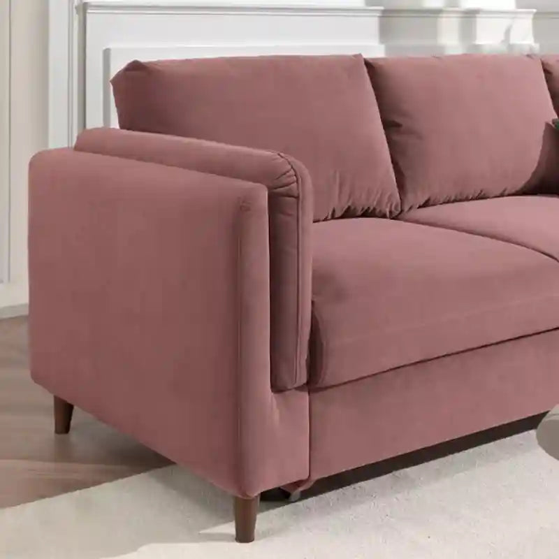 pink pull-out sofa bed showing open lift-up storage compartment for bedding and essentials
