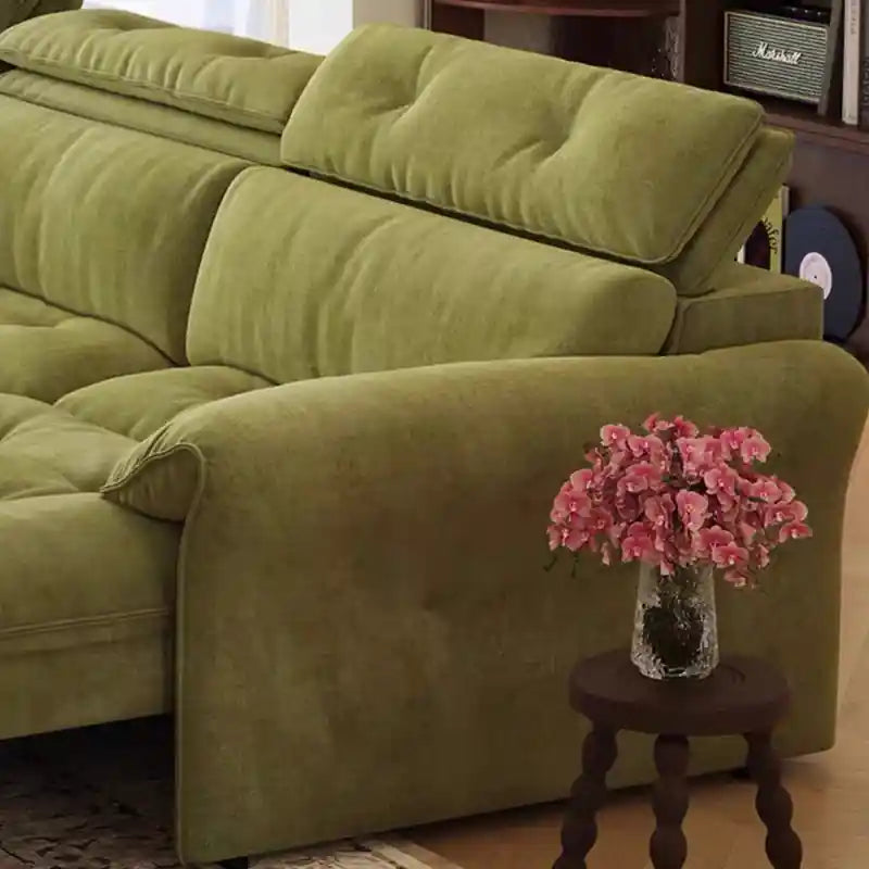green sofa bed couch close-up with soft fabric and caster detail