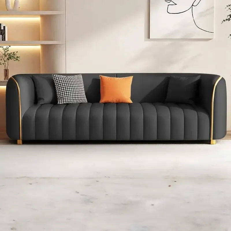 Designer sofa set with curved silhouette, channel-tufted upholstery, wraparound arms, and refined sofa design