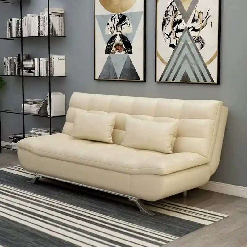 grey sofa bed converted to flat sleeping surface with tufted cushioning and compact sleeper layout