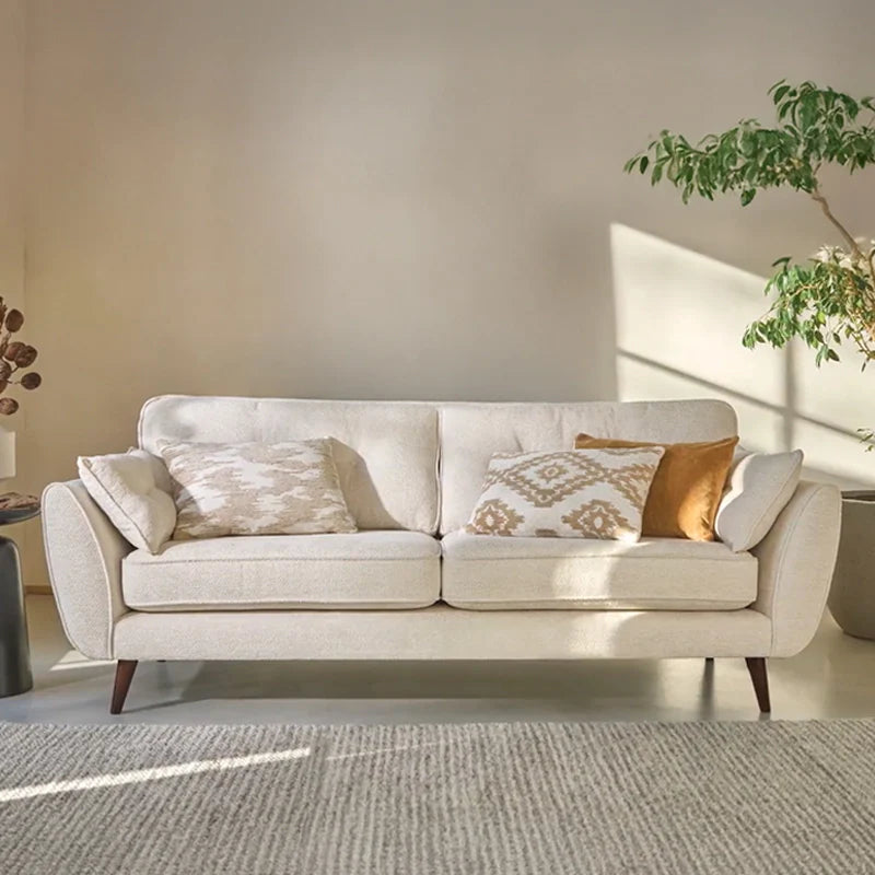 The straight, symmetrical silhouette and rounded arms create a balanced visual presence, while slim metal legs add a light, contemporary touch.