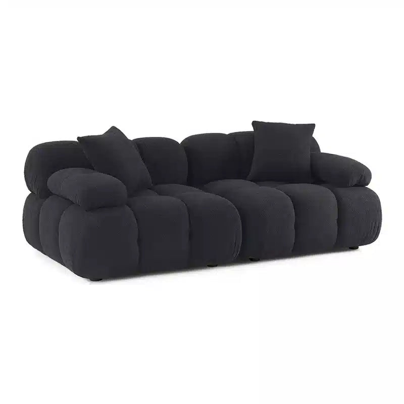 Black sofa with cushioned design on a white background