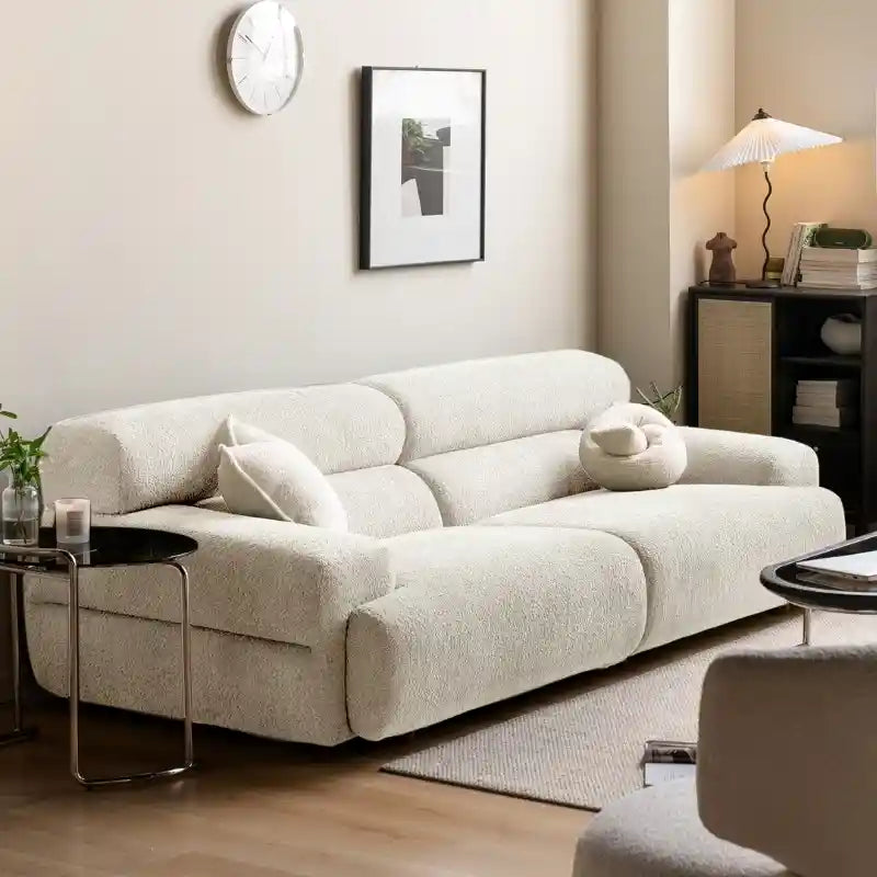 3 seater couch showcases deep fixed cushions, rounded armrests, and low stub legs that visually anchor without dominating space. 