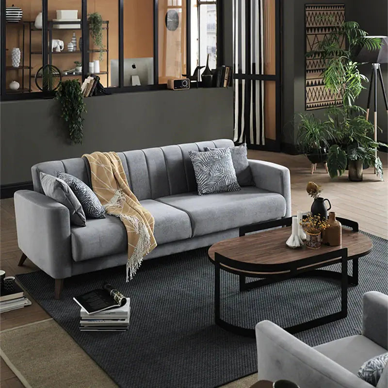 Its linear 3+2+1 layout, wrapped in plush grey velvet-like fabric, showcases a Scandinavian-modern ethos
