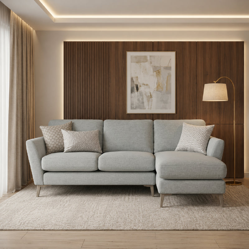 Upholstered in durable grey cloth, this fabric couch is supported by a termite-resistant Neem wood
