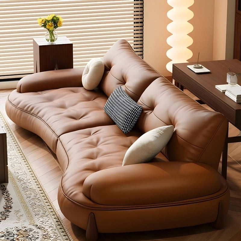 Curved arm lounge seating in caramel tone, modern sofa design, contemporary sofa design, leather