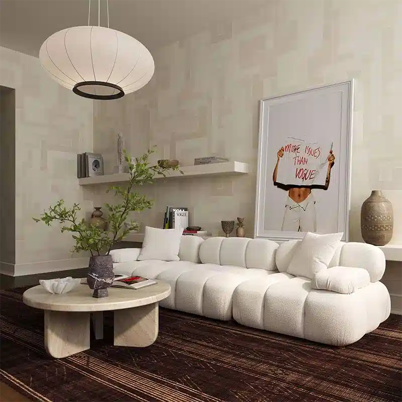 Modern living room with a white sofa, coffee table, and decorative items.