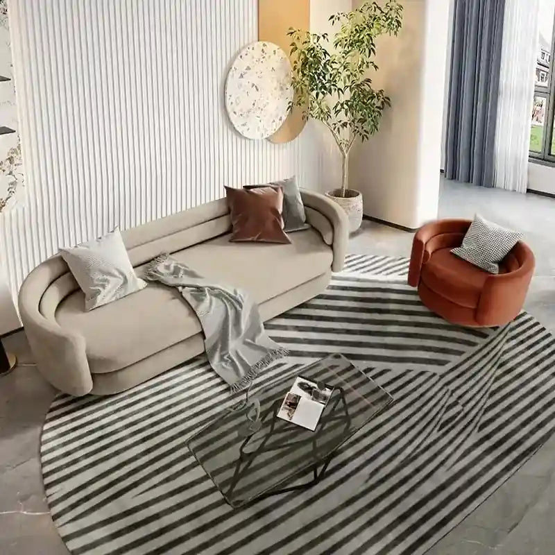 Sculpted cylindrical arms and a soft wraparound back create a grounded silhouette ideal for high-end living rooms.