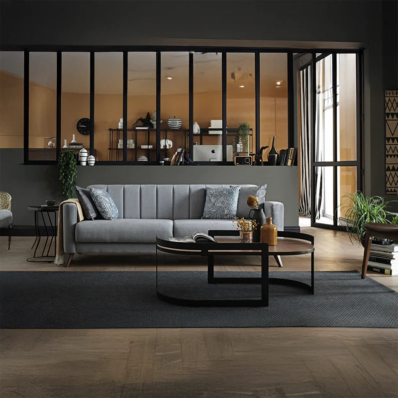 Its linear 3+2+1 layout, wrapped in plush grey velvet-like fabric, showcases a Scandinavian-modern ethos