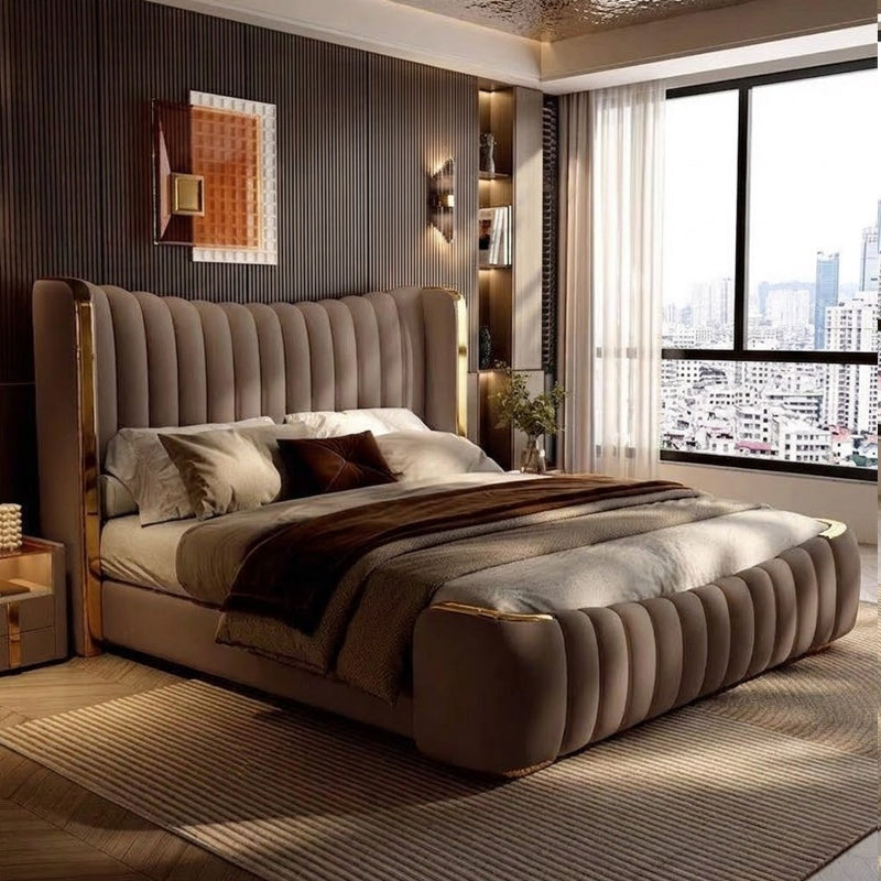 This modern bed design combines plush channel tufting, curved edges, and elegant metallic accents