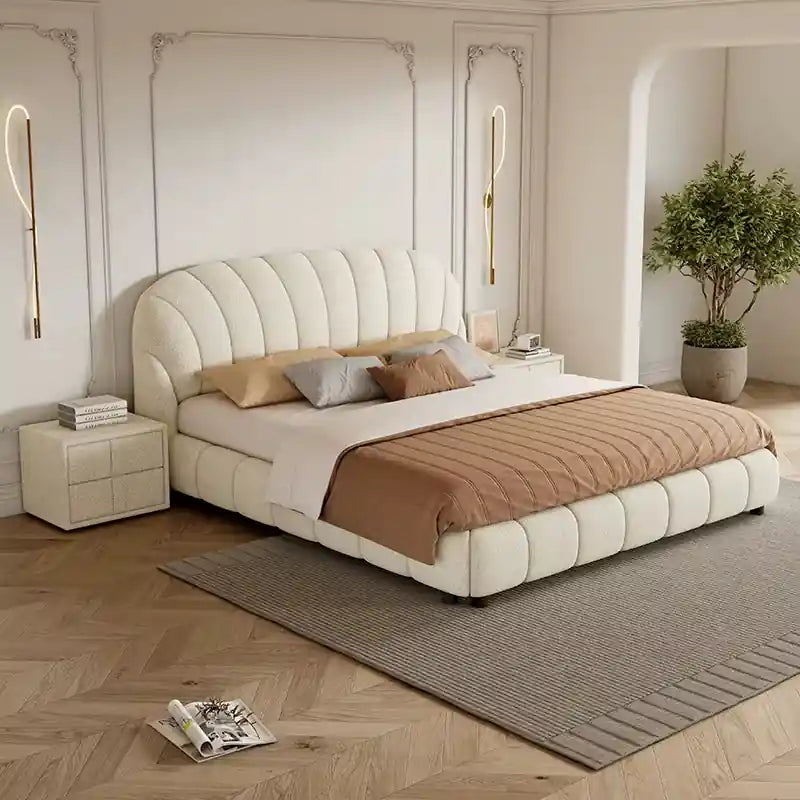 his modern bed design features a curved shell-inspired headboard with deep vertical