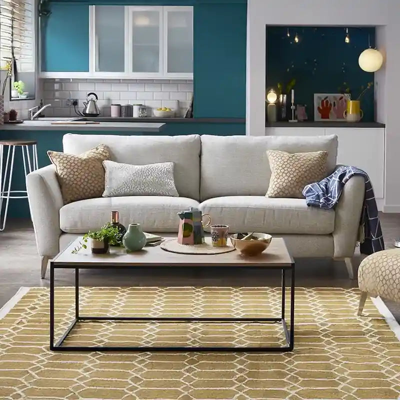 Tapered legs in wood and metal finishes elevate its visual lightness while plush cushions ensure ergonomic comfort