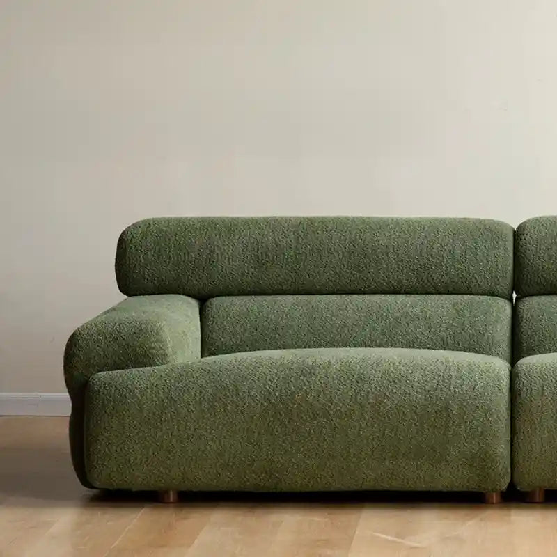Upholstered in a plush boucle fabric, it brings both tactile warmth and stylish form to modern interiors.