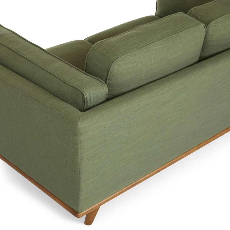 The couch features a straight layout with raised legs, offering a light visual presence