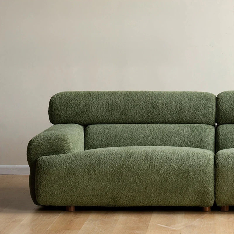 This Scandinavian-modern settee in moss green pairs bold volume with soft textures.