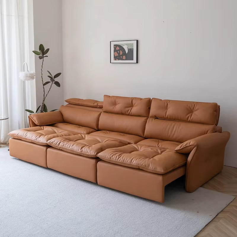Brown leather sectional sofa in a living room with a plant and framed picture on the wall.
