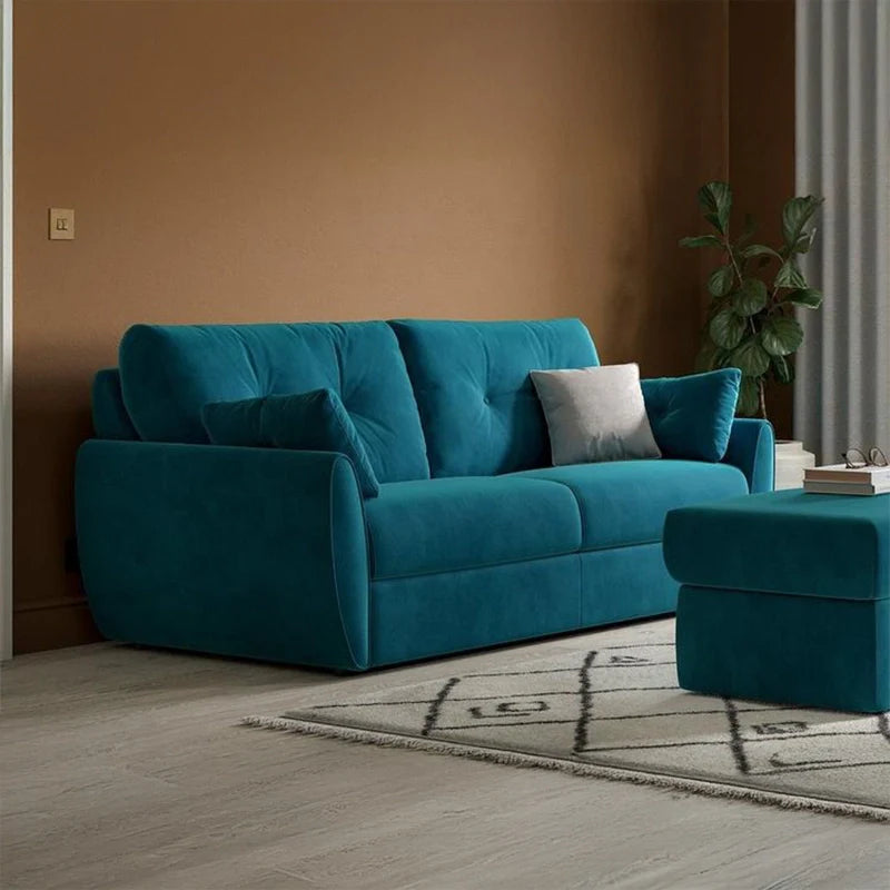 Pull-out sofa bed with tufted backrest, visible metal support frame, quilted mattress surface, rounded armrests, and compact sleeper sofa comfort